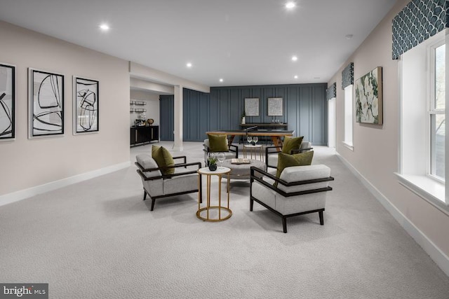 living room featuring baseboards, recessed lighting, and light colored carpet