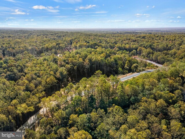 birds eye view of property with a view of trees