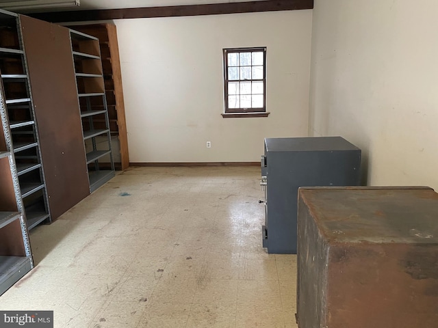 interior space featuring baseboards and light floors