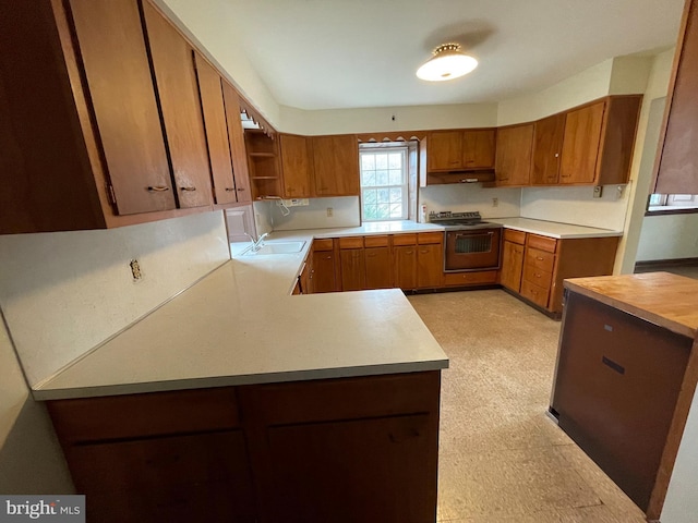 kitchen featuring light countertops, brown cabinets, and light floors