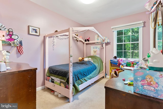 carpeted bedroom featuring baseboards