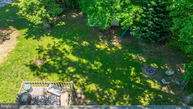 view of grassy yard featuring a wooden deck