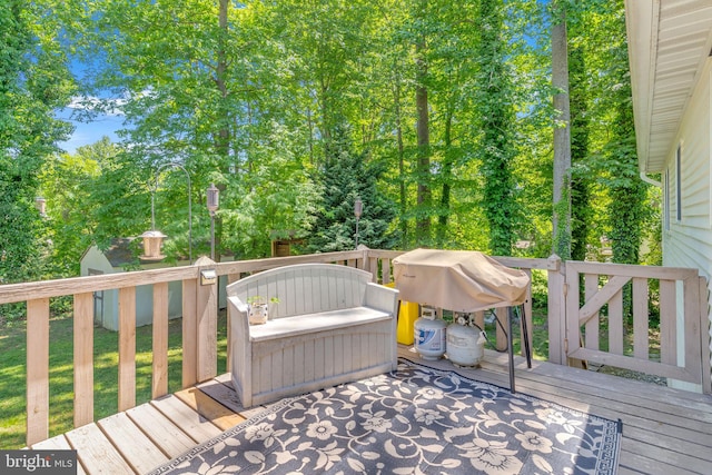 wooden deck with a grill
