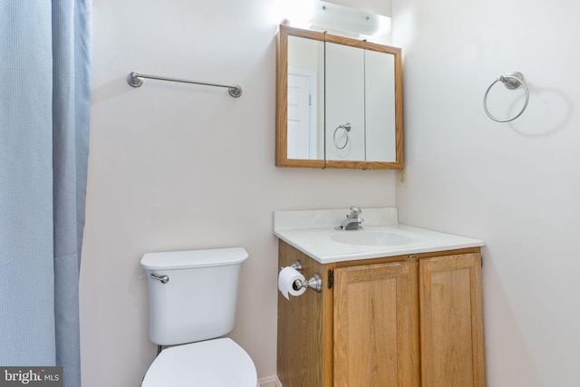 bathroom featuring toilet and vanity