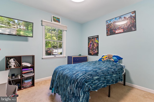bedroom featuring carpet and baseboards