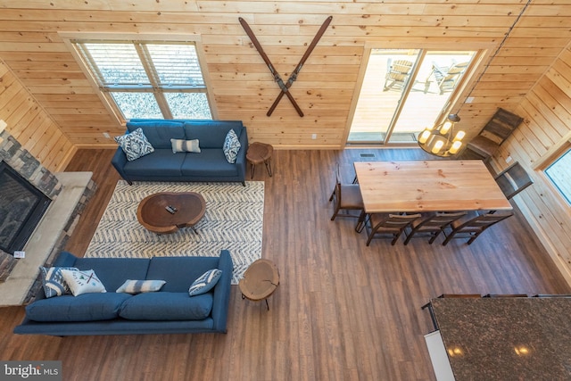 living room featuring wood finished floors, wood walls, and wood ceiling