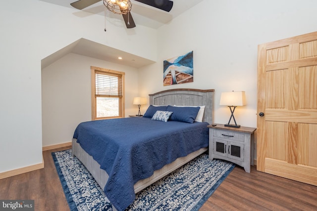 bedroom with ceiling fan, baseboards, vaulted ceiling, and wood finished floors