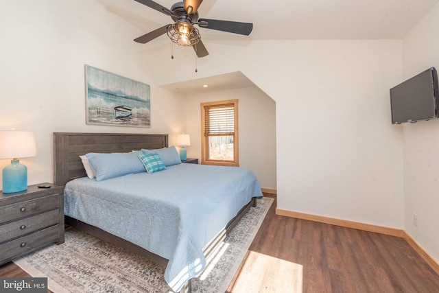 bedroom featuring baseboards, wood finished floors, and a ceiling fan