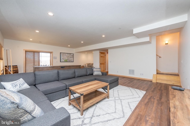 living area featuring stairs, recessed lighting, baseboards, visible vents, and wood finished floors