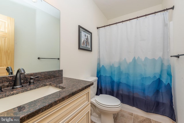 bathroom featuring a shower with curtain, tile patterned floors, toilet, and vanity