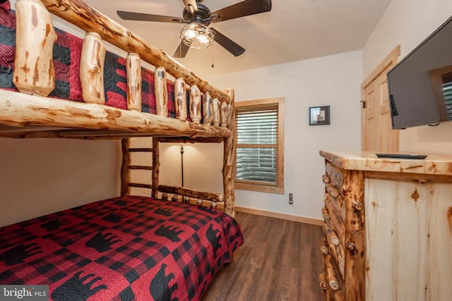 bedroom with a ceiling fan, baseboards, and wood finished floors