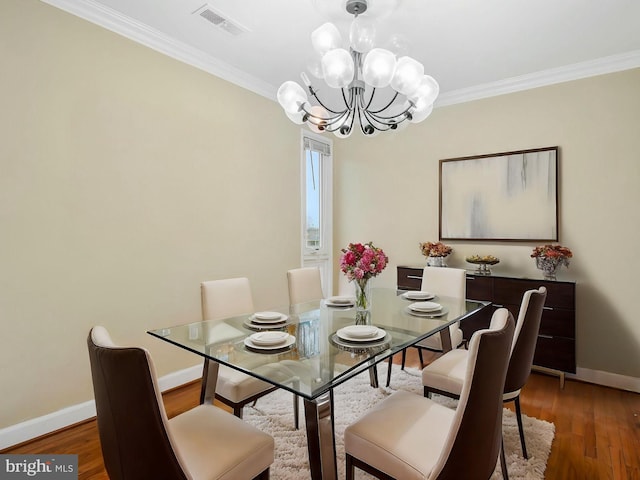 7212 Donnell Pl Unit D5, District Heights, MD 20747 - dining space featuring baseboards, an inviting chandelier, crown molding, visible vents, and wood finished floors