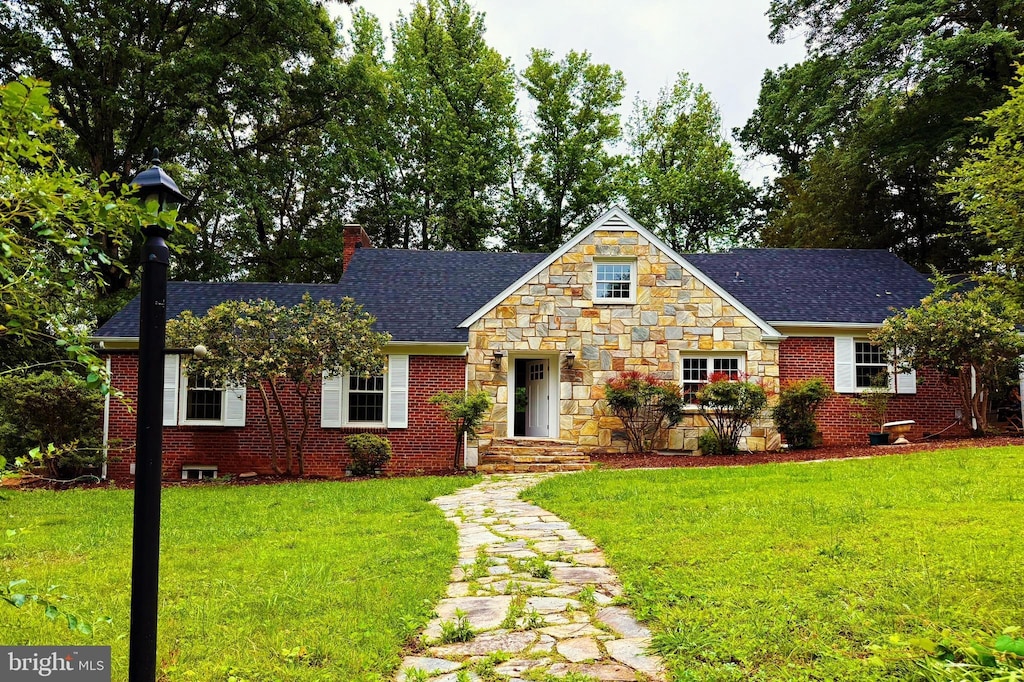 18820 Kerill Rd, Triangle, VA 22172 - view of front of home with roof with shingles, a front lawn, a chimney, stone siding, and brick siding