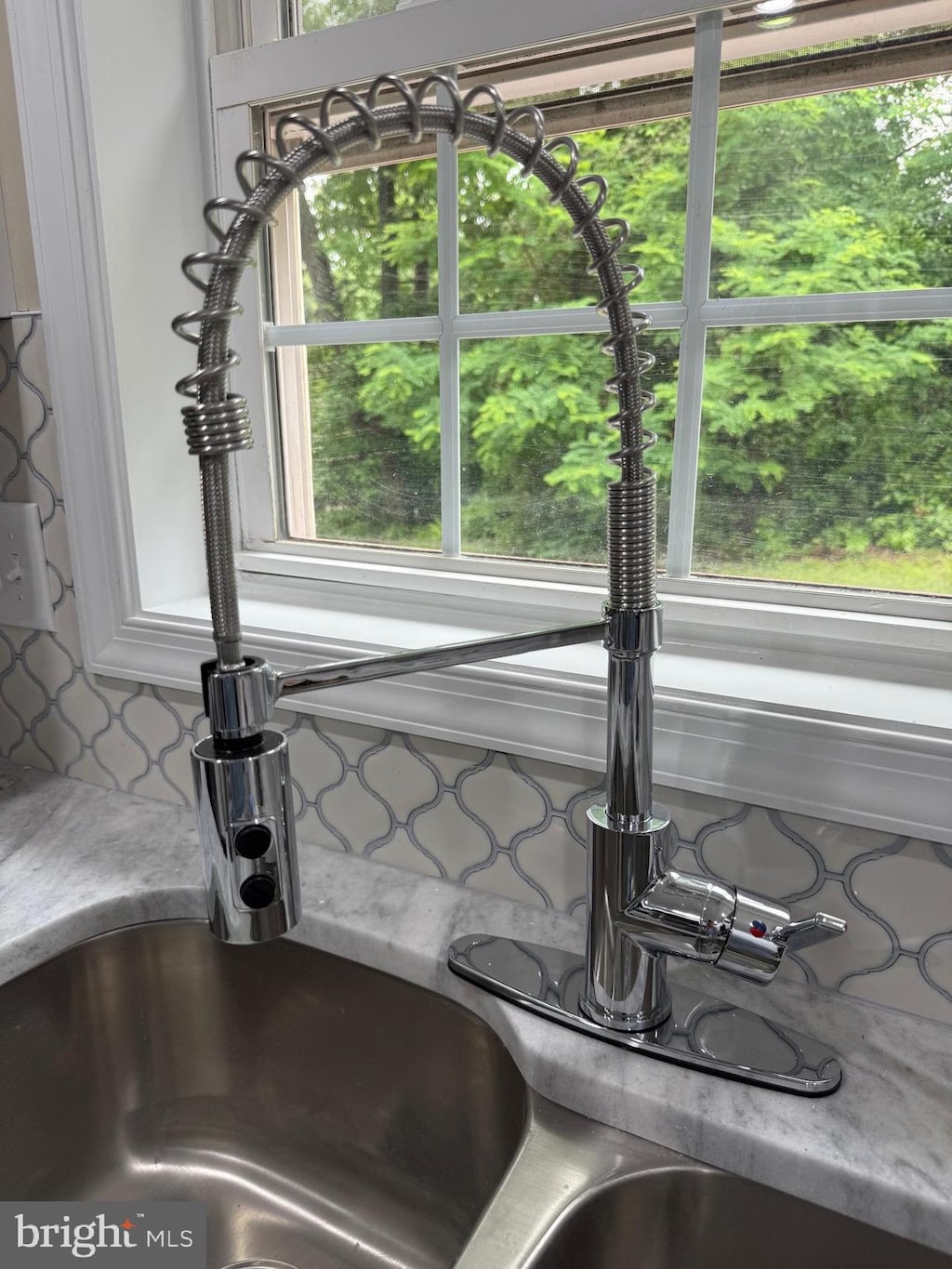 18820 Kerill Rd, Triangle, VA 22172 - kitchen view of a sink, decorative backsplash, and light countertops