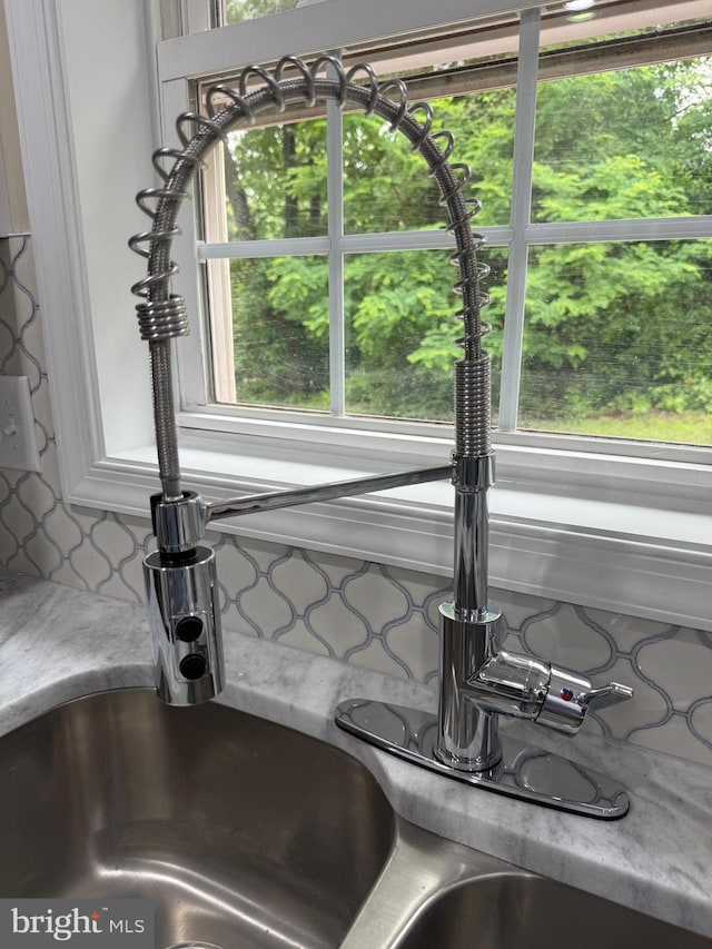 18820 Kerill Rd, Triangle, VA 22172 - kitchen view of a sink, decorative backsplash, and light countertops