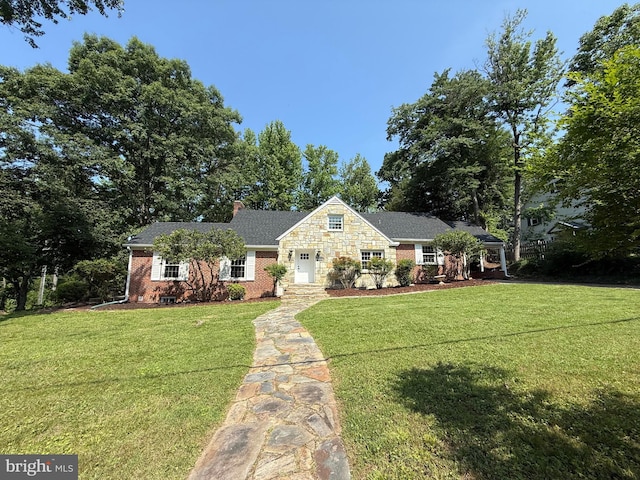 18820 Kerill Rd, Triangle, VA 22172 - view of front of home with a front lawn, a chimney, and brick siding