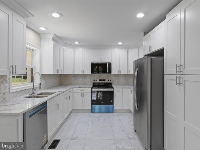 18820 Kerill Rd, Triangle, VA 22172 - kitchen with stainless steel appliances, light marble finish floors, white cabinets, and recessed lighting