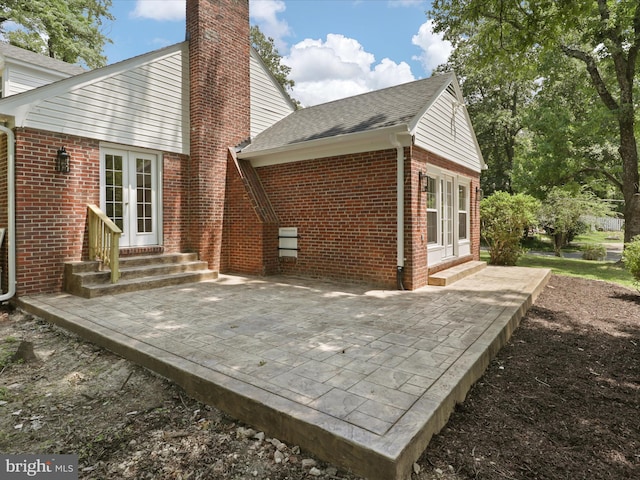 18820 Kerill Rd, Triangle, VA 22172 - back of house featuring entry steps, brick siding, a chimney, and a patio area