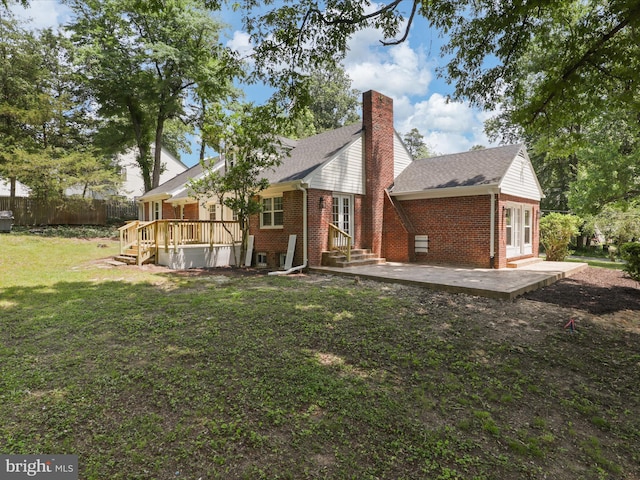 18820 Kerill Rd, Triangle, VA 22172 - back of house featuring brick siding, a chimney, a deck, and a patio area