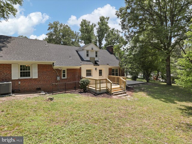 18820 Kerill Rd, Triangle, VA 22172 - back of property with a chimney, a wooden deck, a lawn, and a shingled roof
