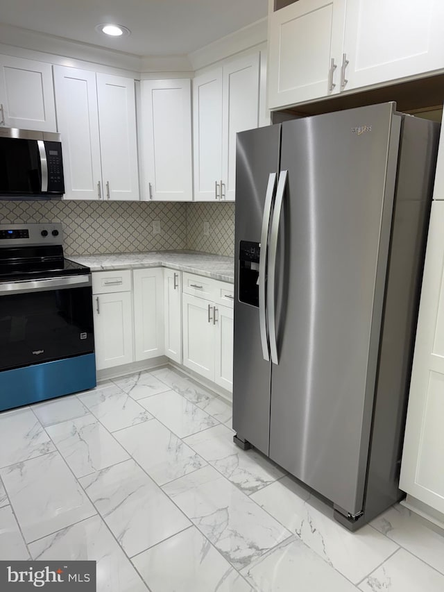 18820 Kerill Rd, Triangle, VA 22172 - kitchen with stainless steel appliances, light marble finish flooring, recessed lighting, white cabinetry, and light stone countertops