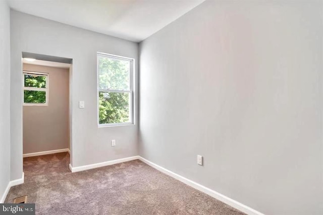 spare room with carpet flooring and baseboards