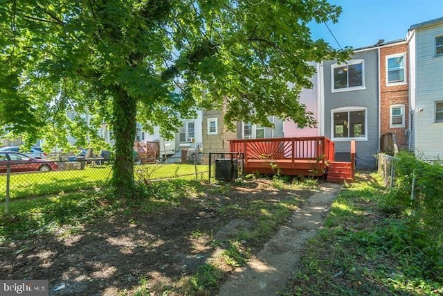 view of yard with a wooden deck, fence, and cooling unit