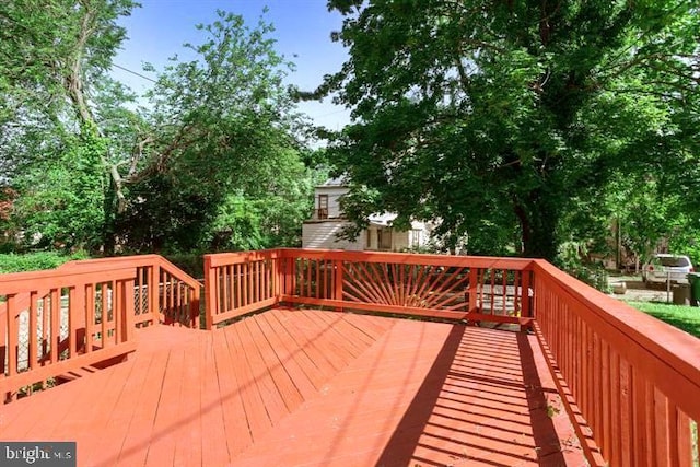wooden deck featuring view of scattered trees