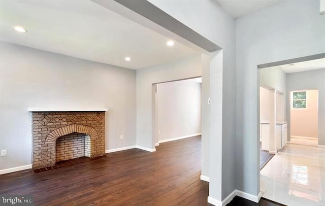 unfurnished living room featuring wood finished floors, baseboards, and recessed lighting