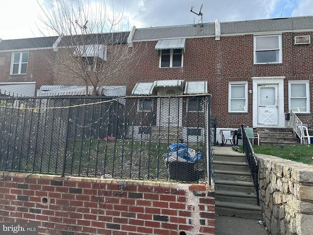 view of front facade with brick siding and entry steps