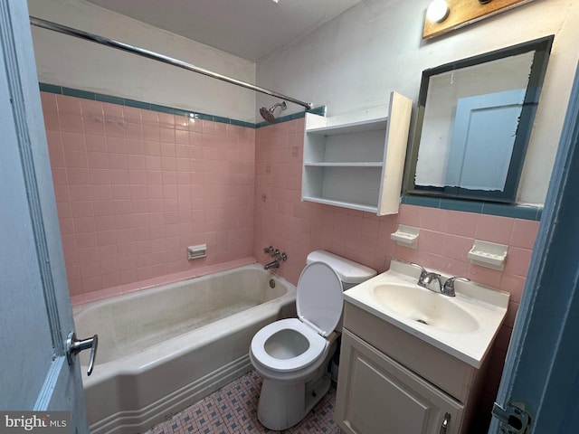 full bathroom featuring vanity, tasteful backsplash, tile walls, toilet, and bathtub / shower combination