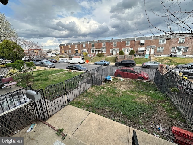 view of yard featuring a residential view and fence