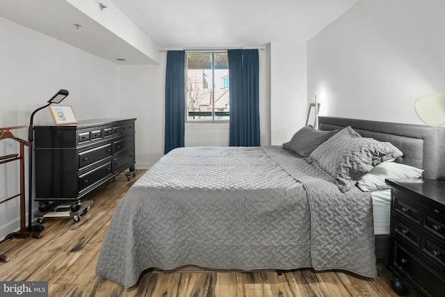 1276 N Wayne St Unit 408, Arlington, VA 22201 - bedroom featuring wood finished floors and baseboards