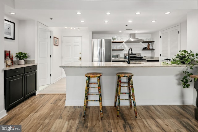 1276 N Wayne St Unit 408, Arlington, VA 22201 - kitchen with open shelves, light wood finished floors, backsplash, and freestanding refrigerator