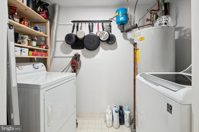 1276 N Wayne St Unit 408, Arlington, VA 22201 - laundry room featuring tile patterned flooring, water heater, washing machine and clothes dryer, and laundry area