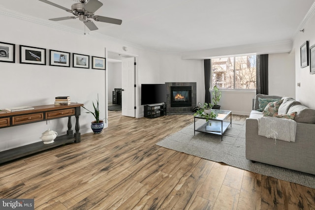 1276 N Wayne St Unit 408, Arlington, VA 22201 - living area with ceiling fan, baseboards, ornamental molding, wood finished floors, and a tiled fireplace