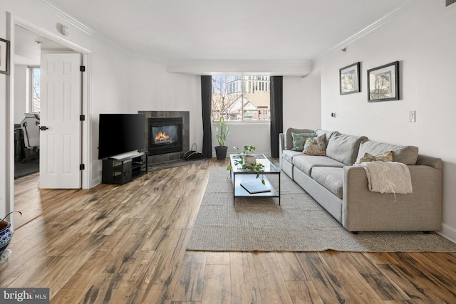 1276 N Wayne St Unit 408, Arlington, VA 22201 - living area with a fireplace, crown molding, visible vents, baseboards, and hardwood / wood-style flooring