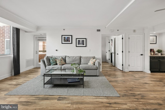 1276 N Wayne St Unit 408, Arlington, VA 22201 - living room with wood finished floors, visible vents, and ornamental molding