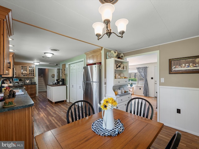 2796 Green Spring Rd, Winchester, VA 22603 - dining area featuring an inviting chandelier, wainscoting, and dark wood-style flooring