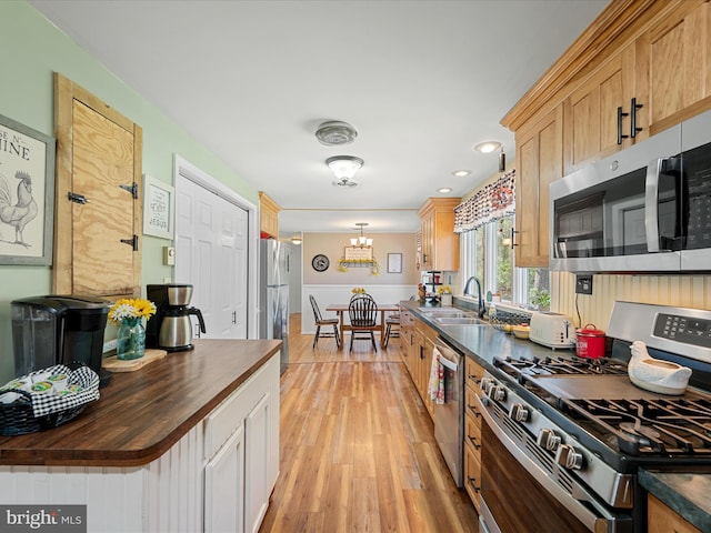 2796 Green Spring Rd, Winchester, VA 22603 - kitchen with an inviting chandelier, a sink, wood counters, stainless steel appliances, and light wood-type flooring