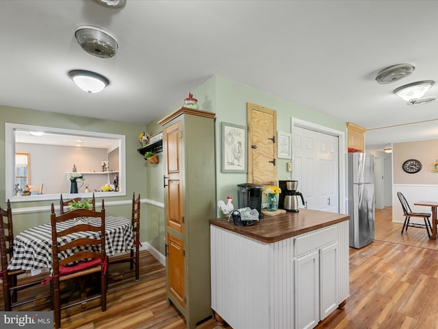 2796 Green Spring Rd, Winchester, VA 22603 - kitchen featuring butcher block countertops, light wood-type flooring, and freestanding refrigerator