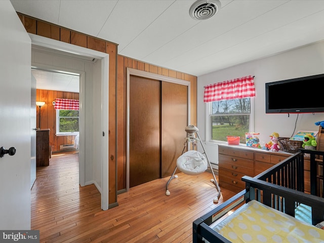 2796 Green Spring Rd, Winchester, VA 22603 - bedroom with wood walls, visible vents, hardwood / wood-style floors, and a closet