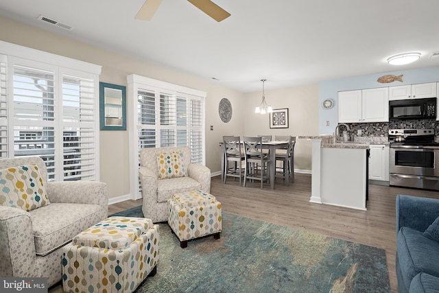12301 Jamaica Ave Unit E21605, Ocean City, MD 21842 - living room with wood finished floors, baseboards, ceiling fan, and visible vents