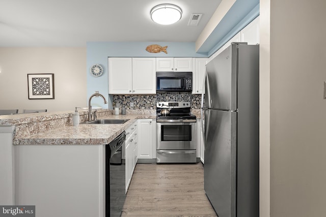 12301 Jamaica Ave Unit E21605, Ocean City, MD 21842 - kitchen with visible vents, a peninsula, white cabinetry, a sink, and black appliances