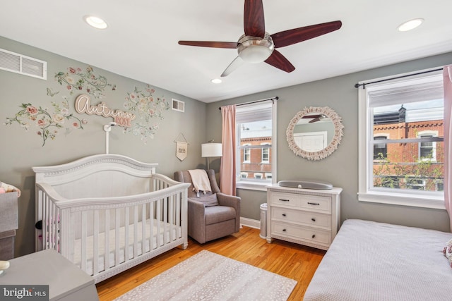 bedroom with light wood-type flooring, recessed lighting, and visible vents