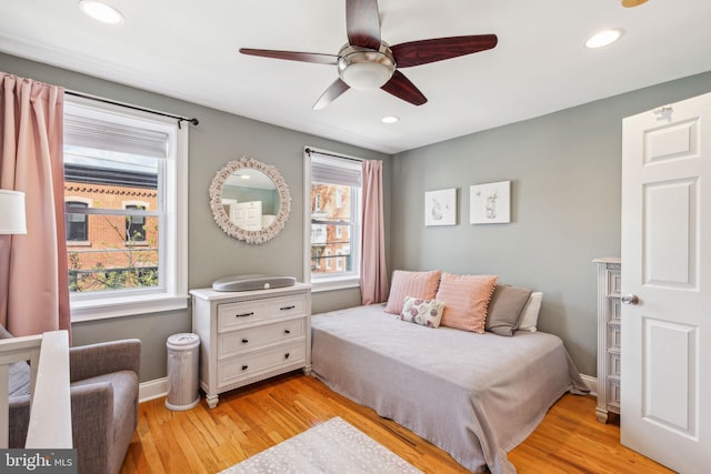 bedroom with recessed lighting, light wood-style flooring, and multiple windows