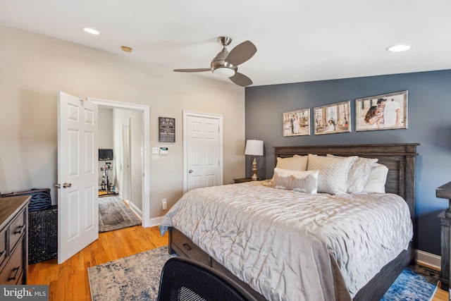 bedroom with baseboards, light wood-type flooring, recessed lighting, and a ceiling fan