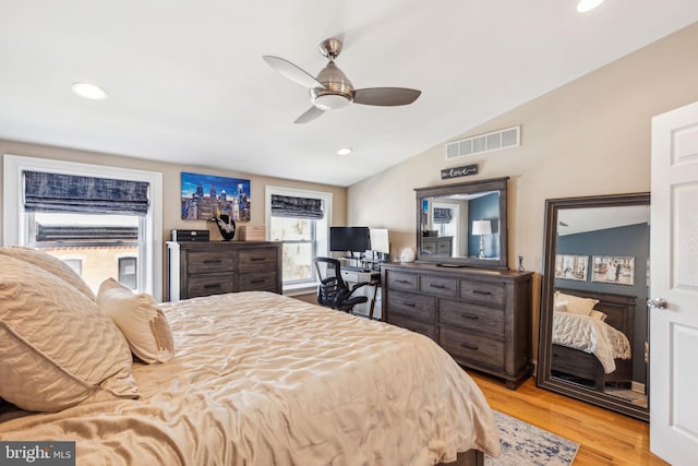 bedroom featuring visible vents, vaulted ceiling, recessed lighting, and wood finished floors