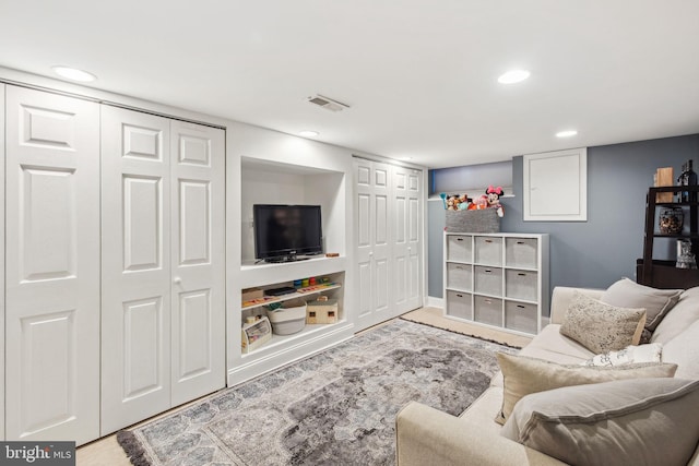 living area featuring recessed lighting and visible vents