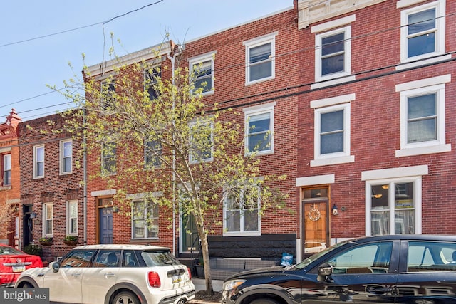 townhome / multi-family property featuring brick siding